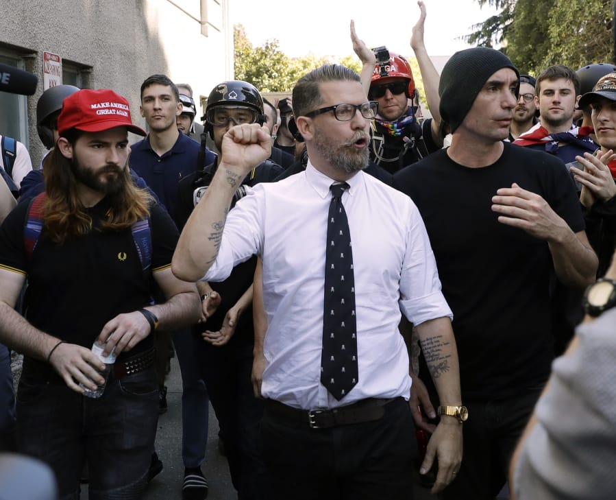 Gavin McInnes, center, founder of the far-right group the Proud Boys, is surrounded by supporters after speaking at a rally in Berkeley, Calif., in April 2017.