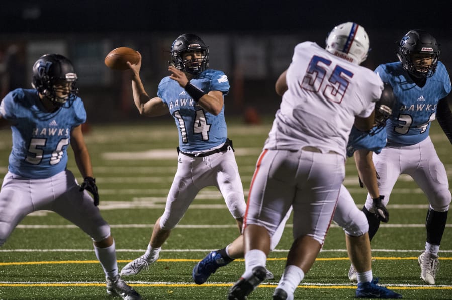 Hockinson’s potent offense which produced 3,571 passing yards and 52 touchdown passes from quarterback Levi Crum (14, above), got its start when Rick Steele (below left) returned as head coach in 2014 and hired Josh Racanelli (below center) as offensive coordinator. His offense helped Hockinson win its first state title (below right) in 2017.
