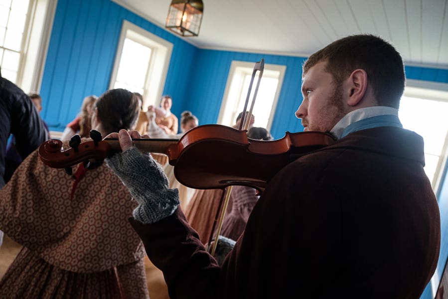 A violin player provides the live music while dancers get moving at the 2016 Christmas at Fort Vancouver event.
