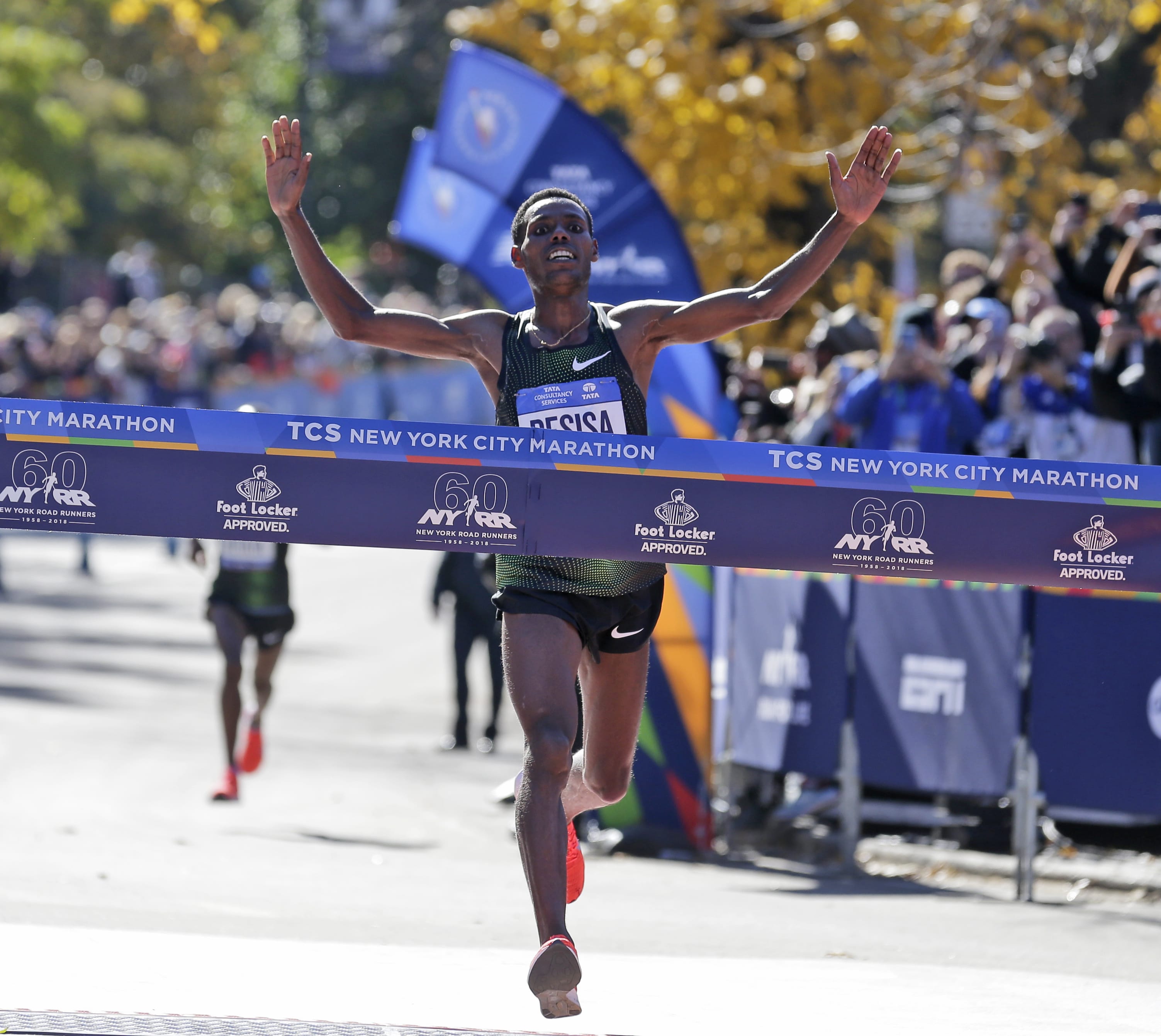 Lelisa Desisa, of Ethiopia, crosses the finish line first in the men's division of the New York City Marathon in New York, Sunday, Nov. 4, 2018.
