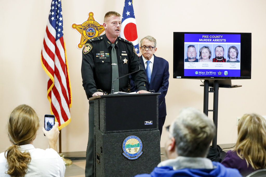 Pike County Sheriff Charles Reader, left, speaks alongside Ohio Attorney General Mike DeWine, right, during a news conference to discuss developments into the slayings of eight members of one family in rural Ohio two years ago, Tuesday, Nov. 13, 2018, in Waverly, Ohio.A family of four, the Wagner family, who lived near the scenes of the killings, was arrested Tuesday.