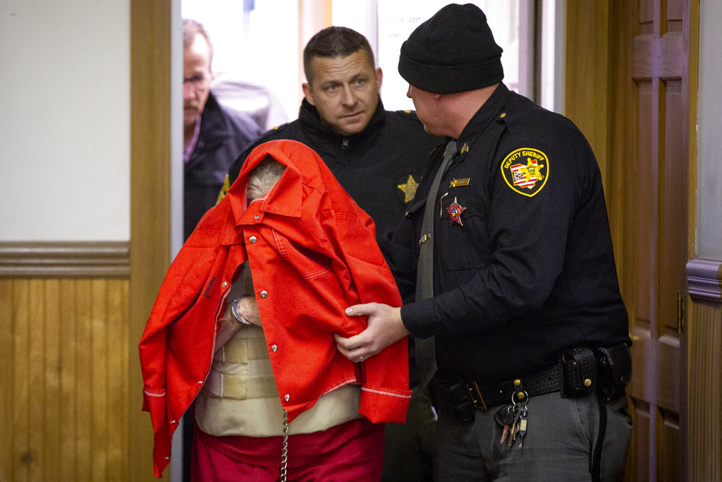Fredericka Wagner, 76, of Lucasville, Ohio, covers her face as she walks into the Pike County Courthouse for her arraignment Thursday, November 15, 2018 in Piketon, Ohio. Wagner, and Rita Newcomb, 65, of South Webster, are accused of perjury and obstructing justice for allegedly misleading investigators; Newcomb also is charged with forging custody documents to cover up the crimes. The women are mothers of Angela Wagner and George "Billy" Wagner and grandmothers of the Wagners' two sons, George Wagner IV and Edward "Jake" Wagner, who are facing murder charges. The killings took place in 2016.