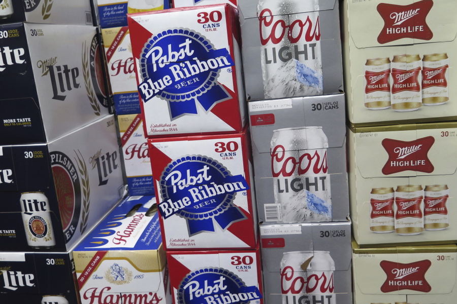 Cases of Pabst Blue Ribbon and Coors Light are stacked next to each other Thursday in a Milwaukee liquor store.