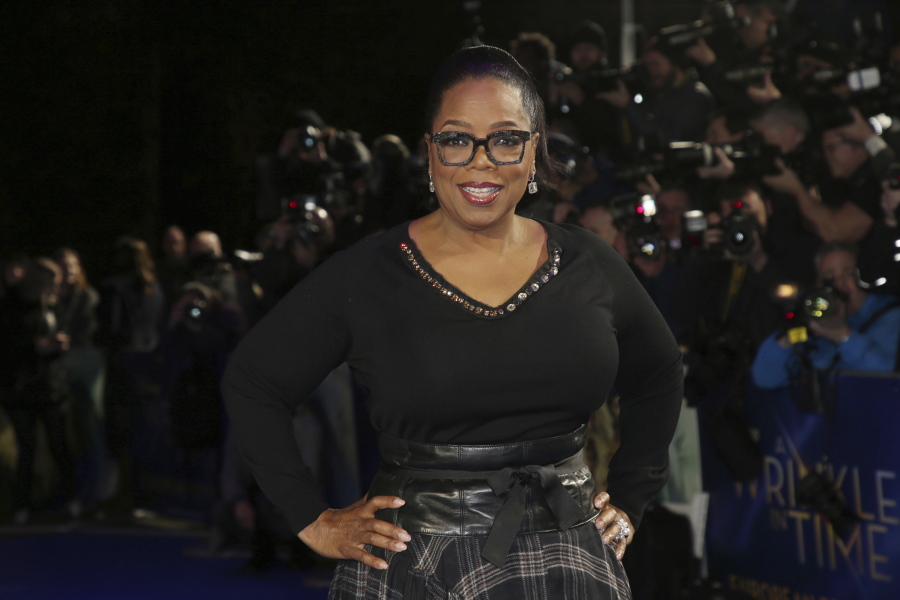 Actress Oprah Winfrey poses for photographers upon arrival at the premiere of the film ‘A Wrinkle In Time’ in London. Winfrey has chosen Michelle Obama’s “Becoming” as her next book club pick, The Associated Press has learned. In a statement Monday, Nov. 12, Winfrey said the memoir was “well-written” and inspirational.