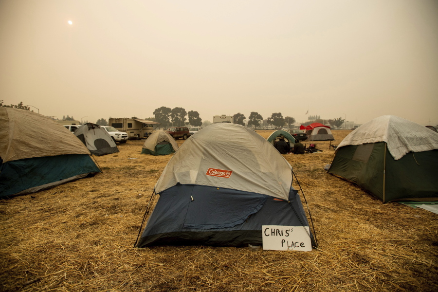 A sign sits beside a tent at an area for evacuees of the Camp Fire on Wednesday in Chico, Calif.