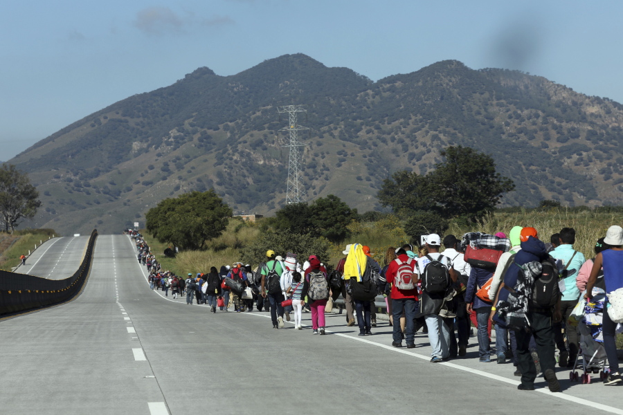 Central American migrants travel toward the U.S. border Tuesday on the highway that connects Guadalajara with Tepic, Mexico. Some migrants have arrived in Tijuana.