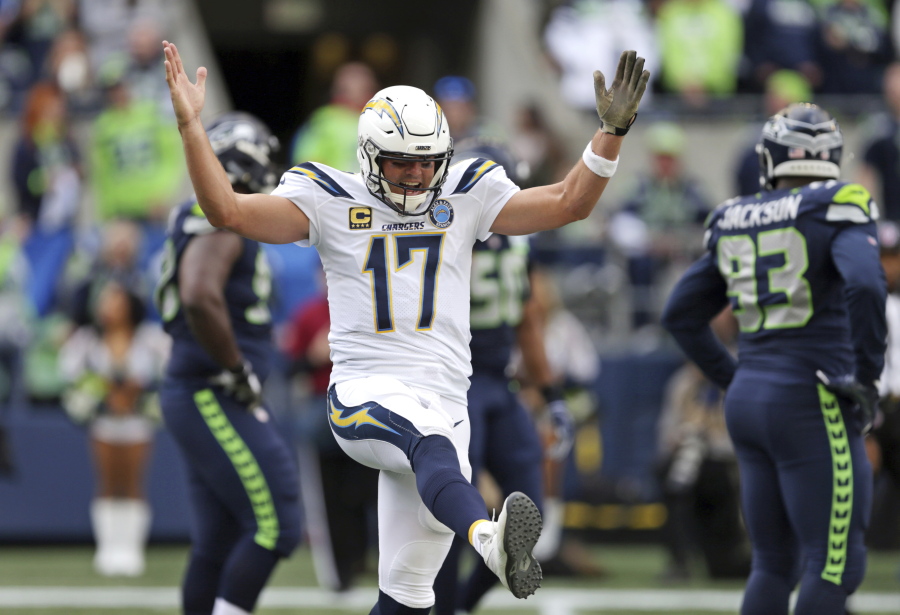 Los Angeles Chargers quarterback Philip Rivers celebrates a touchdown by the team against the Seattle Seahawks during the first half of an NFL football game, Sunday, Nov. 4, 2018, in Seattle.