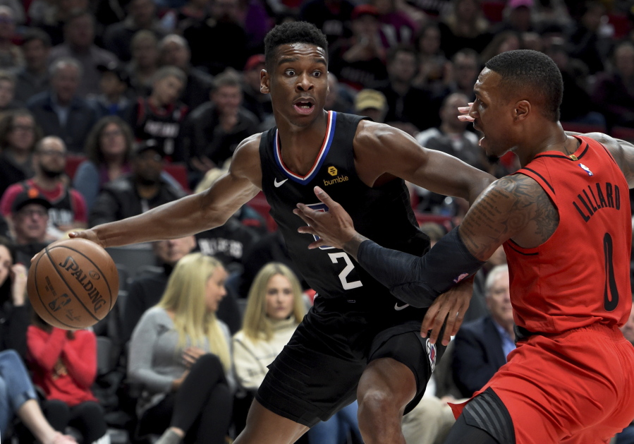 Los Angeles Clippers guard Shai Gilgeous-Alexander, left, tries to get past Portland Trail Blazers guard Damian Lillard, right, during the first half of an NBA basketball game in Portland, Ore., Thursday, Nov. 8, 2018.