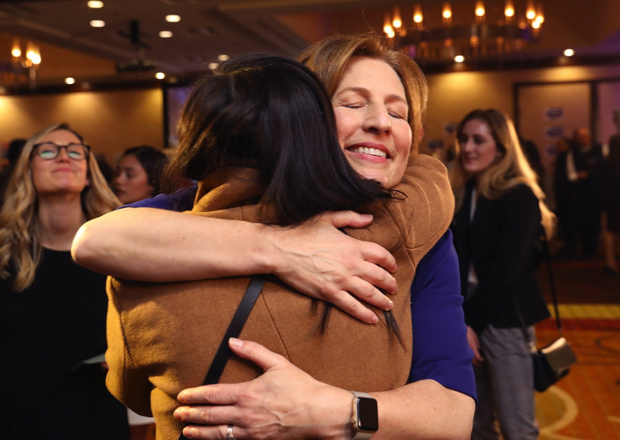 On election night Kim Schrier, facing camera, who is running for the 8th Congressional District, hugs a supporter at a victory party for Democrats on Tuesday in Bellevue.