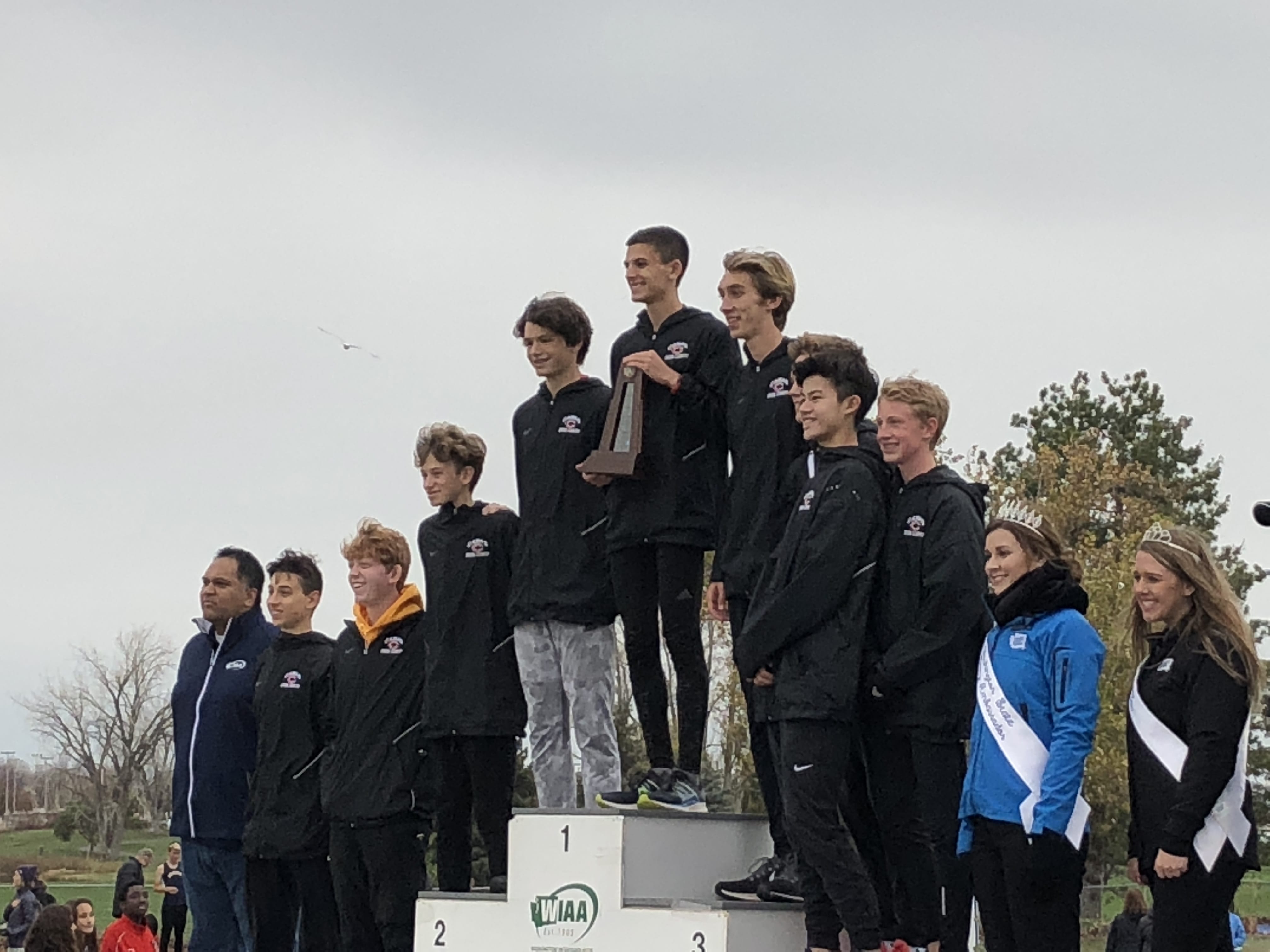 The Camas boys team claims the third-place trophy in Class 4A at the WIAA State Cross Country Championships Saturday in Pasco.