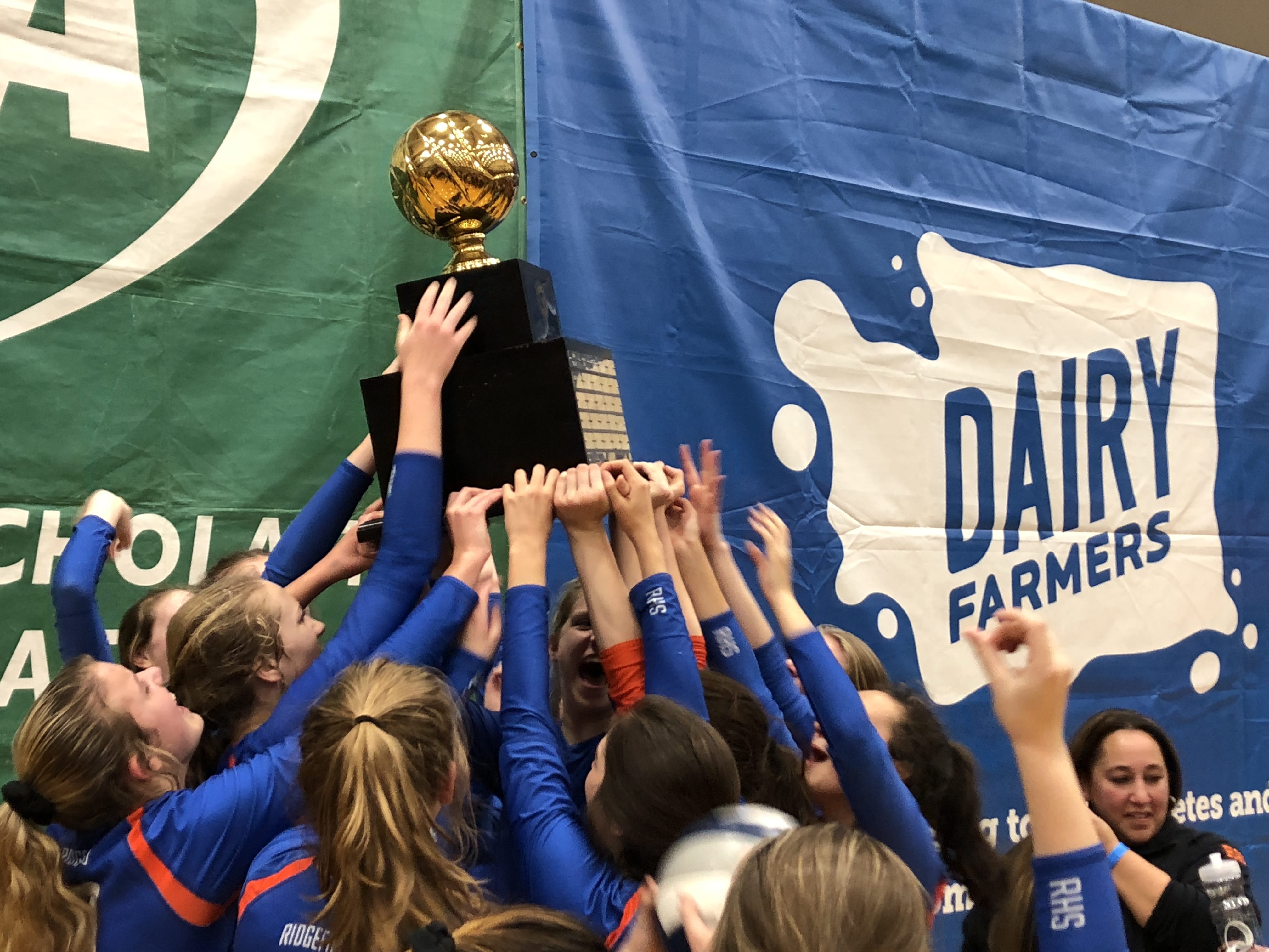 The Ridgefield volleyball team lifts the 2018 Class 2A state championship trophy after beating Lynden in the title match at Saint Martin's University.