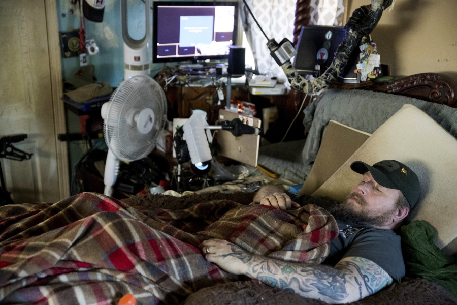 Jim Taft watches The History Channel from the confines of his bed Nov. 16 at his home in West Columbia, S.C. Taft has experienced debilitating health issues after a neurosurgeon implanted Boston Scientific’s Precision spinal cord stimulator in his back in 2014.