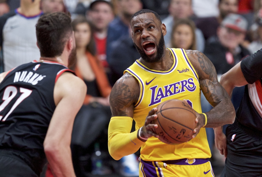 Los Angeles Lakers forward LeBron James, right, drives to the basket towards Portland Trail Blazers center Jusuf Nurkic during the first half of an NBA basketball game in Portland, Ore., Saturday, Nov. 3, 2018.