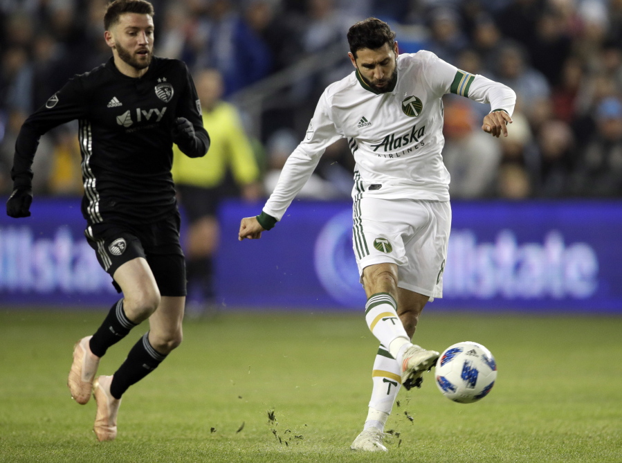 Portland Timbers midfielder Diego Valeri (8) shoots on net ahead of Sporting Kansas City midfielder Ilie Sanchez, left, during the first half in the second leg of the MLS soccer Western Conference championship in Kansas City, Kan., Thursday, Nov. 29, 2018.