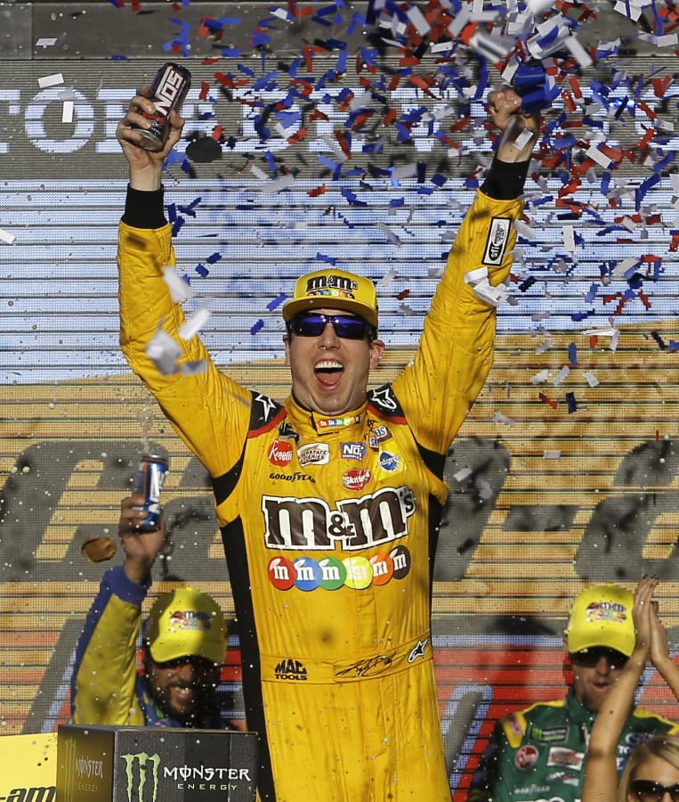 Kyle Busch (18) celebrates after winning a NASCAR Cup Series auto race on Sunday, Nov. 11, 2018, in Avondale, Ariz.