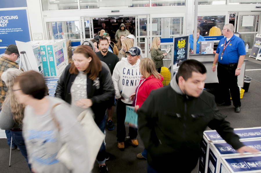 FILE- In this Nov. 23, 2017, file photo shoppers enter a Best Buy looking for early Black Friday deals on Thanksgiving Day in Bowling Green, Ky. A solid 70 percent of Americans plan to shop on Black Friday this year, according to a recent NerdWallet study conducted by The Harris Poll.