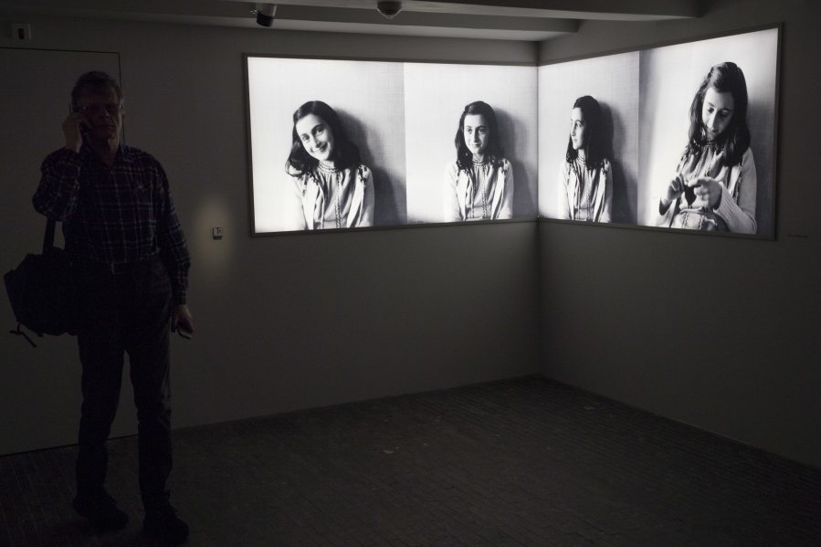 A journalist takes the audio tour Wednesday of the renovated Anne Frank House Museum in Amsterdam, Netherlands.
