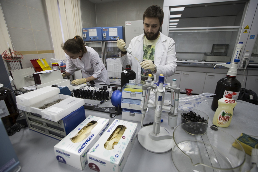 Lab technicians work at Russia’s national drug-testing laboratory in Moscow, Russia. A delegation from the World Anti-Doping Agency arrived for talks Wednesday with Russian authorities in Moscow as it tries to access data which could mean more bans for top Russian athletes who cheated in past years.