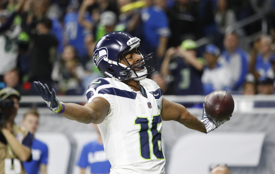 Seattle Seahawks wide receiver Tyler Lockett reacts after his 24-yard reception for a touchdown during the first half of an NFL football game against the Detroit Lions, Sunday, Oct. 28, 2018, in Detroit.