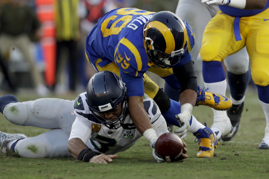 Los Angeles Rams defensive end Dante Fowler forces a fumble against the Seattle Seahawks during the second half in an NFL football game Sunday, Nov. 11, 2018, in Los Angeles.