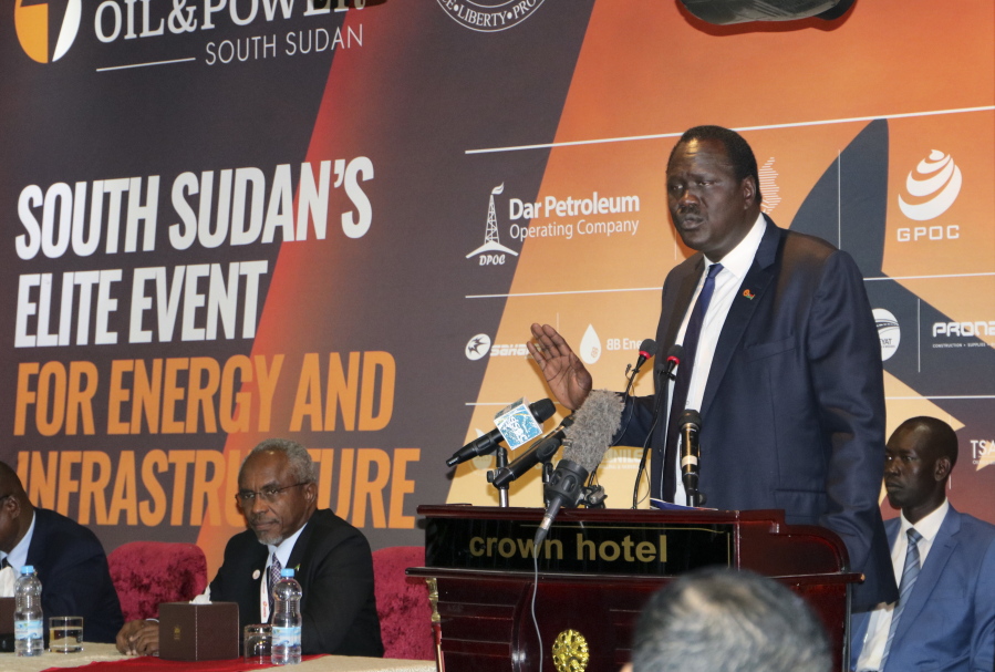 In this photo taken Tuesday, Nov. 20, 2018, South Sudan’s Minister of Petroleum Ezekiel Lol Gatkuoth welcomes potential investors during the second Africa Oil and Power conference in the capital Juba, South Sudan. South Sudan is making its first big foreign investment pitch since declaring an end to its civil war, but the oil-rich nation seems to face hesitation from some companies that want to make sure the fragile new peace deal holds.