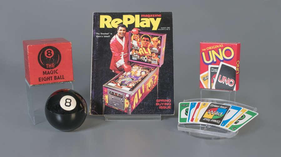 The toys to be inducted into the National Toy Hall of Fame, inside the Rochester, N.Y., museum. The class of 2018 honored Thursday, Nov. 8, includes, from left, the Magic 8 Ball, pinball and the card game Uno.
