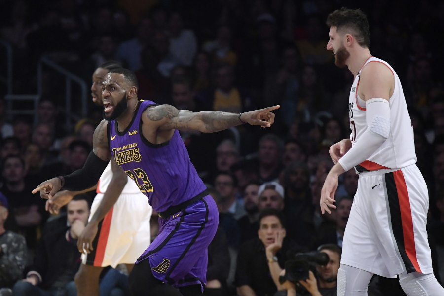 Los Angeles Lakers forward LeBron James, left, reacts to an inadvertent whistle by a referee as Portland Trail Blazers center Jusuf Nurkic watches during the first half of an NBA basketball game Wednesday, Nov. 14, 2018, in Los Angeles. (AP Photo/Mark J.
