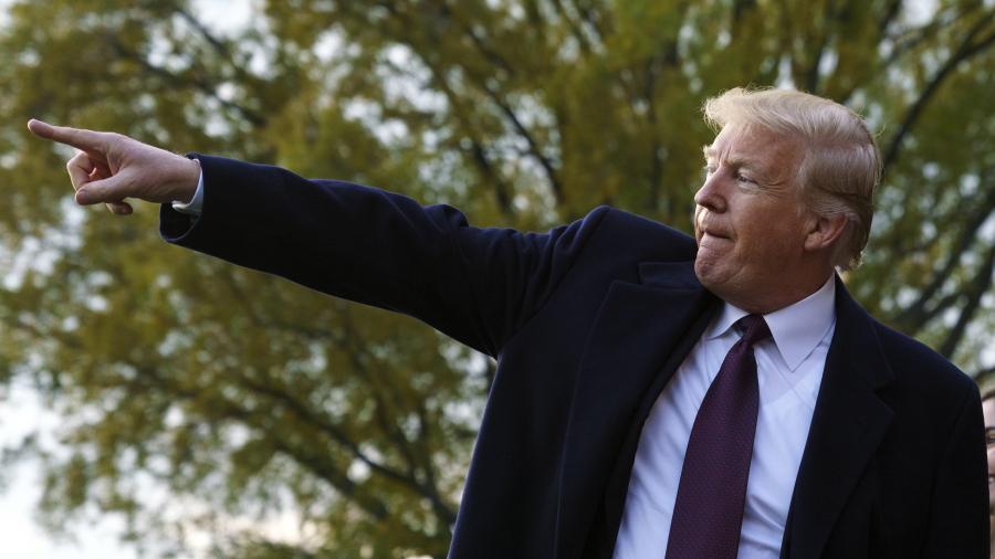 President Donald Trump points as he greets supporters before boarding Marine One on the South Lawn of the White House in Washington, Tuesday, Nov. 20, 2018, for the short trip to Andrews Air Force Base and on to n route to Palm Beach International Airport, in West Palm Beach, Fla., and onto Mar-a-lago.