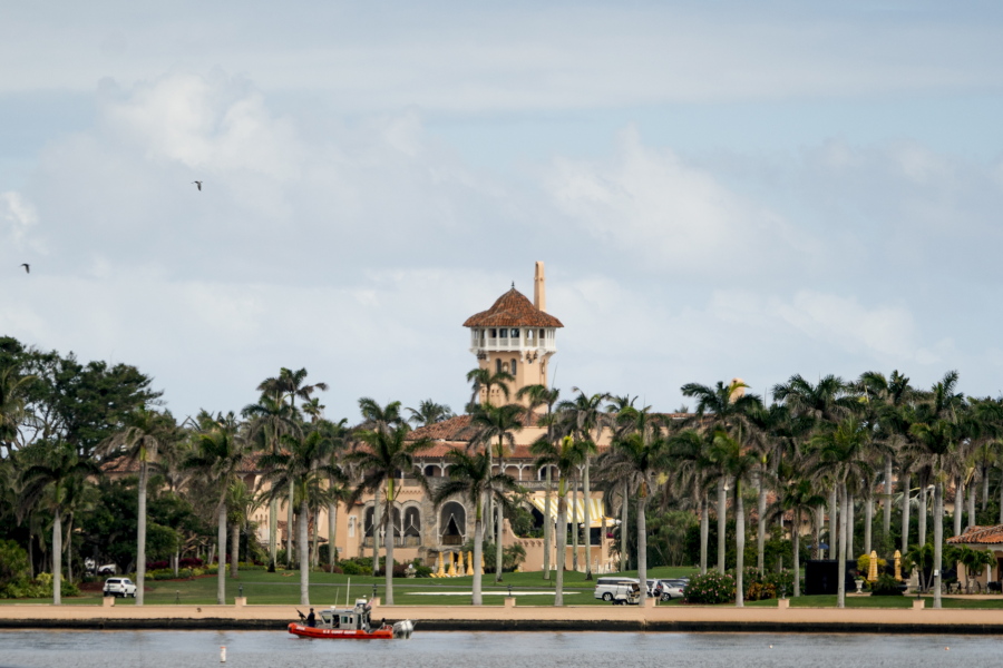 FILE - In this Feb. 19, 2018, file photo, Mar-a-Lago is visible from a motorcade carrying President Donald Trump, in Palm Beach, Fla. Trump is making his return to Florida, kicking off the Palm Beach social season at his “winter White House.” All presidents have had their favorite refuges from Washington.