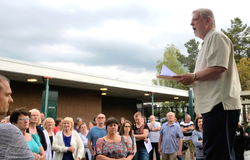 Doug Sheddy speaks to a crowd opposing the adoption of "High School FLASH" in July at Battle Ground Public Schools. Critics of the curriculum say its lessons on gender identity and sexual orientation are not appropriate for children.