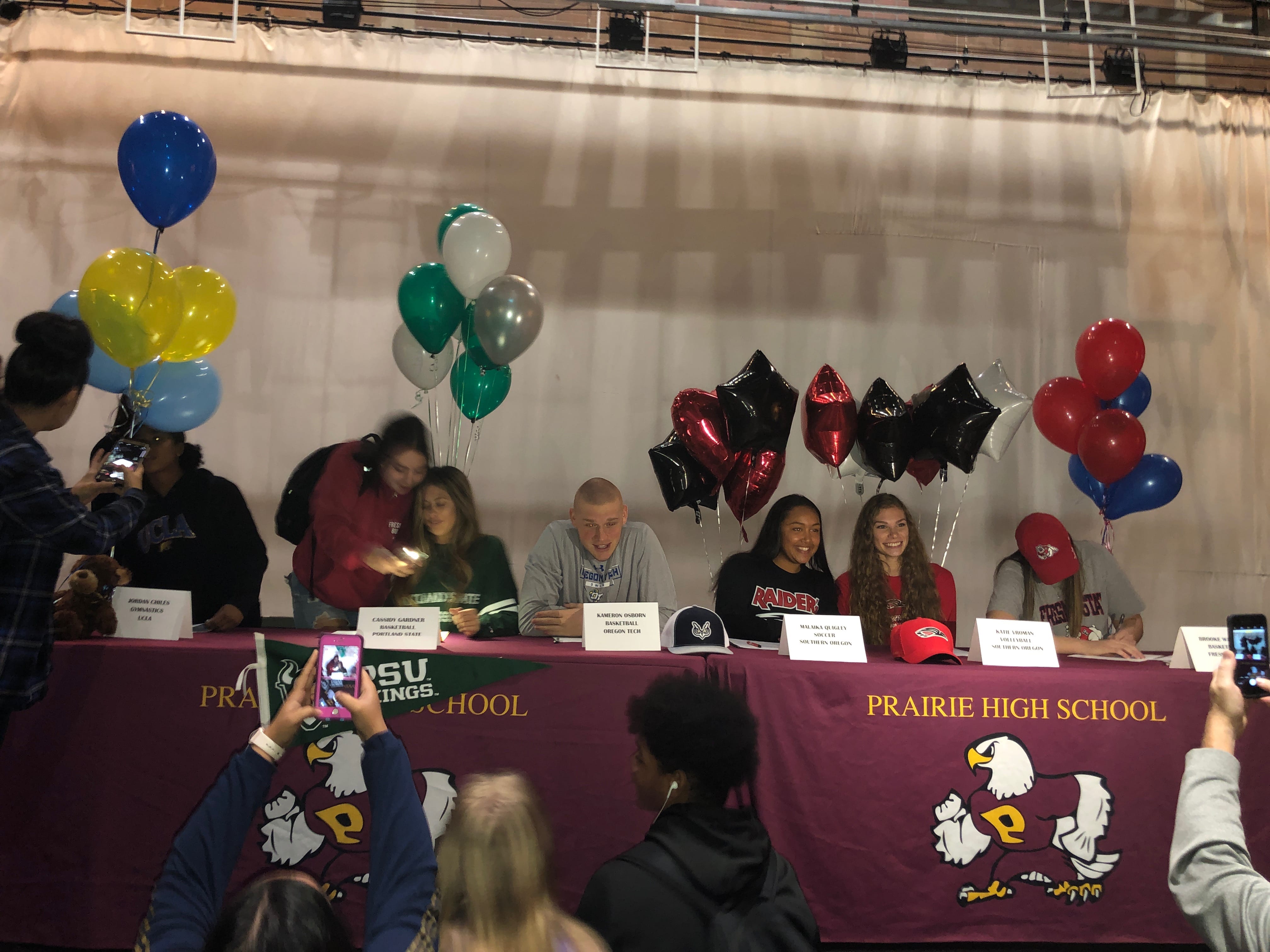 Six students sign national letters of intent to play college athletics on Wednesday at Prairie High School.
