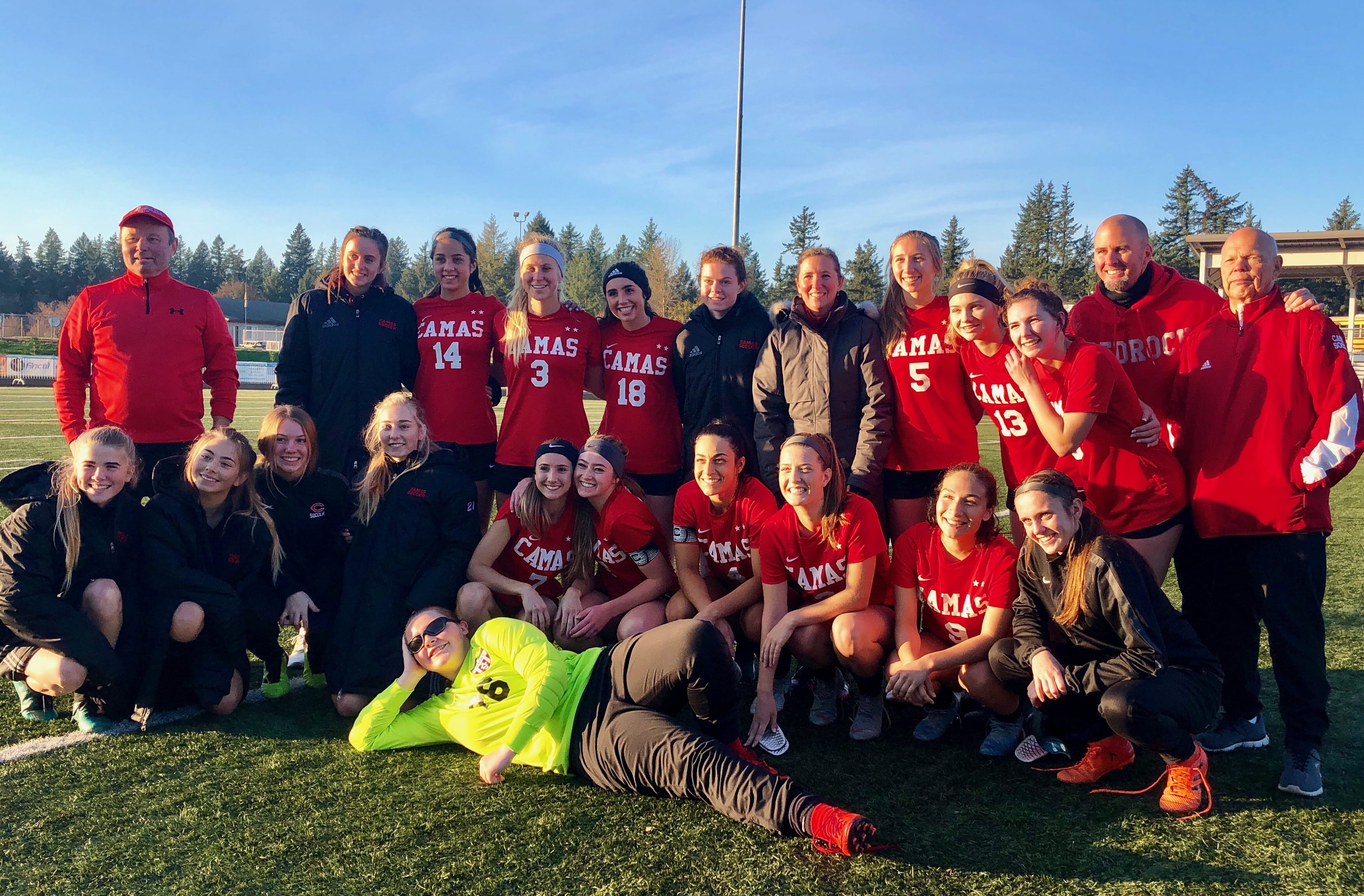 The Camas girls soccer team poses with coach Roland Minder after a 4-2 win over Bellarmine Prep in the 4A state quarterfinals at Doc Harris Stadium. On Saturday, Nov. 10, 2018.