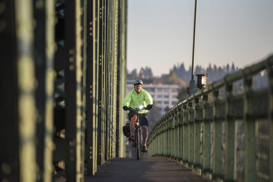 Dan Herrigstad rides his e-bike across the Interstate 5 Bridge as part of his morning commute from his east Vancouver home to the Portland Veterans Affairs Medical Center near the Oregon Health and Science University campus.