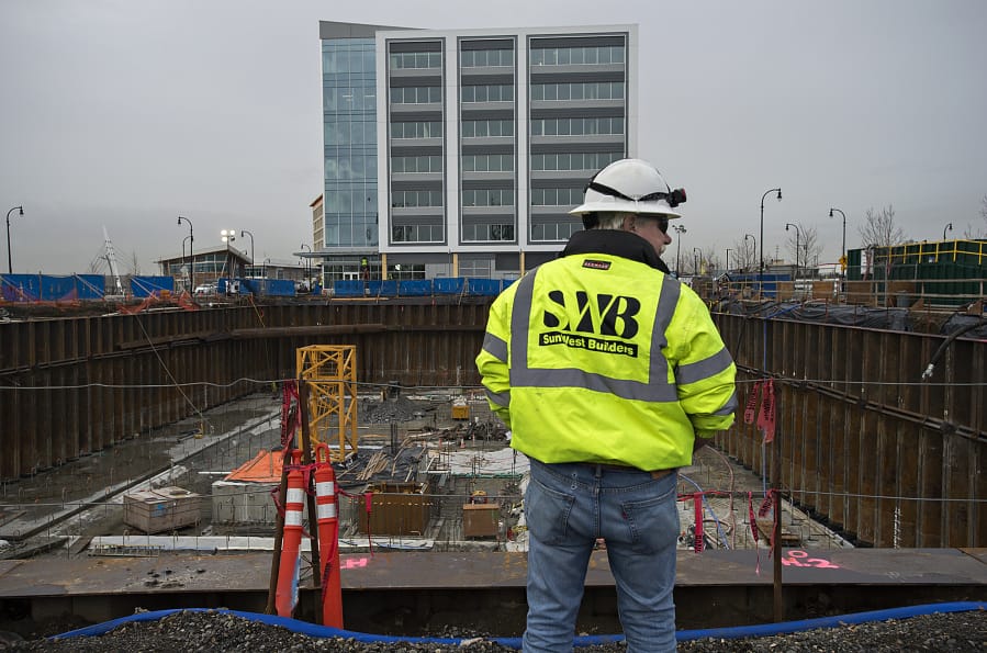 Project superintendent James Fuller of Kirkland Construction Group looks over the future site of the Kirkland Tower and Hotel Indigo, which includes the tower crane base, in yellow, Wednesday afternoon.
