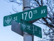 Street signs for the Southeast First Street and Southeast 170th Avenue.