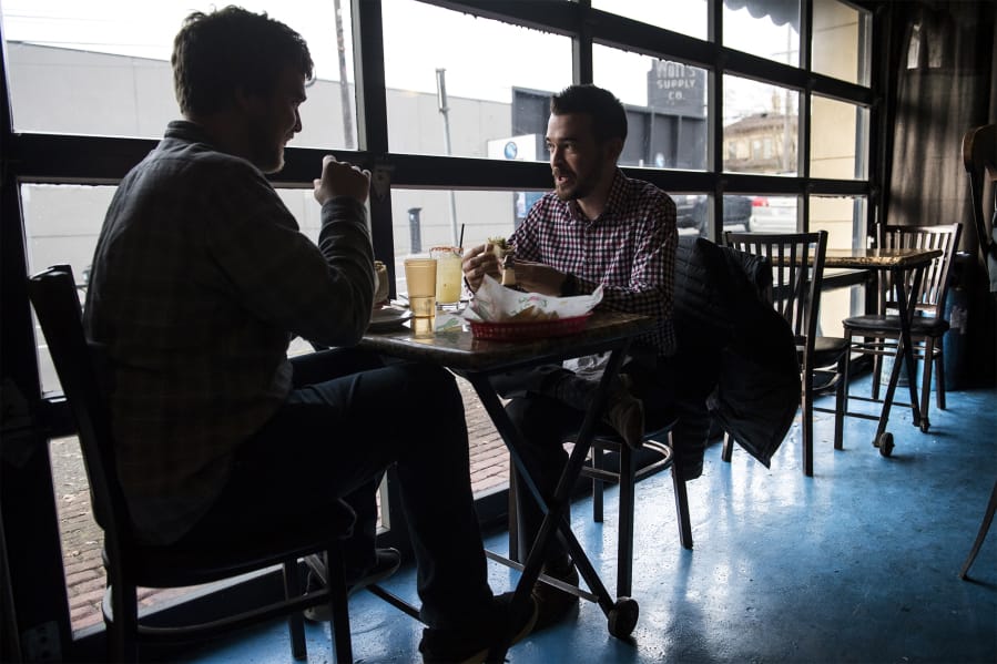 Andrew Willson, left, and A.J. Roberts eat lunch at Woody’s Tacos on Friday afternoon, a week before the popular downtown eatery is scheduled to close.