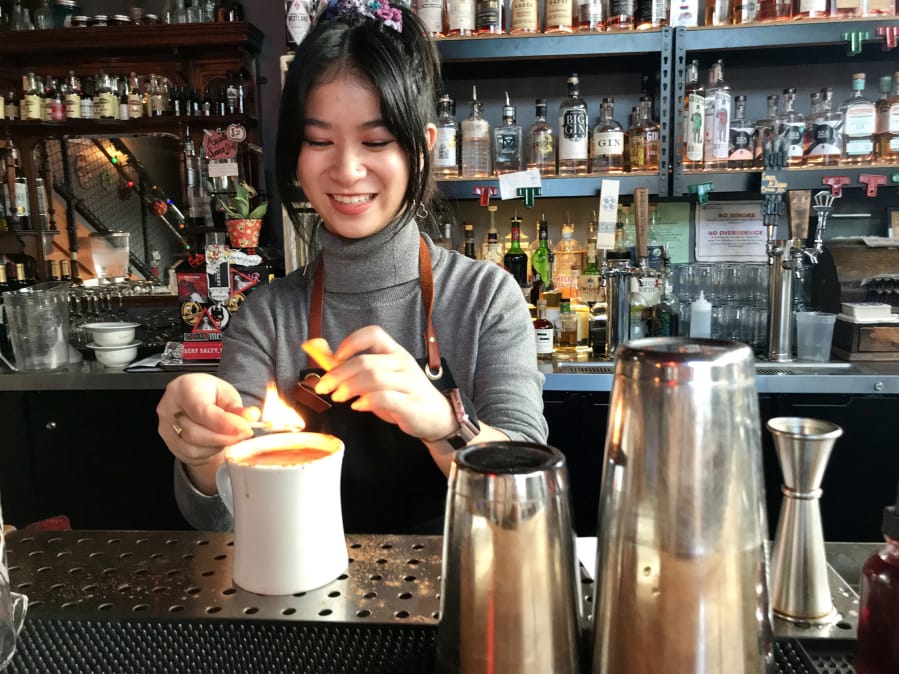Bartender Juliana Chau prepares Nana’s Lovin’ at The Grocery Cocktail & Social.