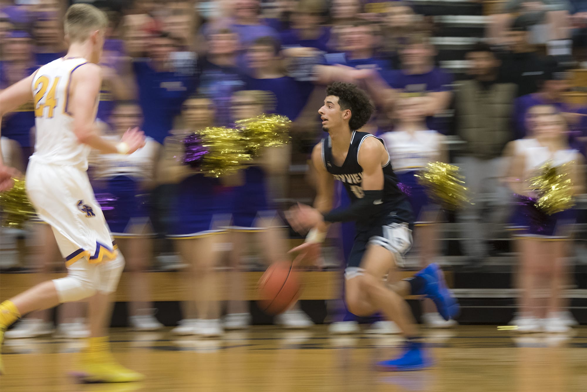 Skyview's Alex Schumacher takes the ball up the court against Columbia River during a match at Columbia River High School on Friday night, Dec. 14, 2018.