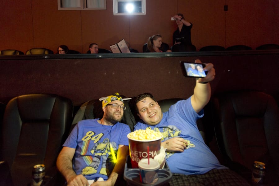 Sean Nance, left, and Eli Schwartz, who both run the podcast “All Aboard The Hype Train,” take a photo during a viewing of “Bumblebee,” the newest film in the Transformer’s franchise, at Vancouver’s Cinetopia Cinema.