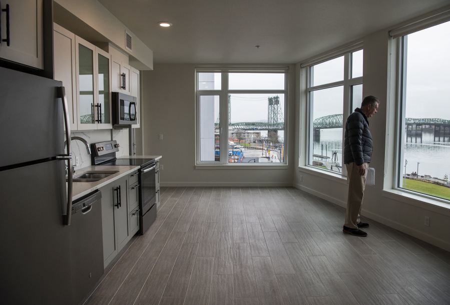 Jim Edwards, Gramor Development project director, views the Columbia River from a one-bedroom apartment at the new Rediviva apartment building at The Waterfront Vancouver. The building opened to tenants last week.