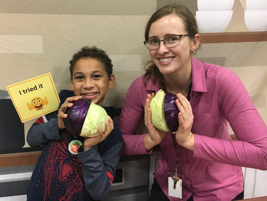 Hearthwood: Eyo Colbert, left, and Nicole Nissen Hooper at Hearthwood Elementary School, which hosted this month’s Harvest of the Month program. The featured local ingredient was cabbage.