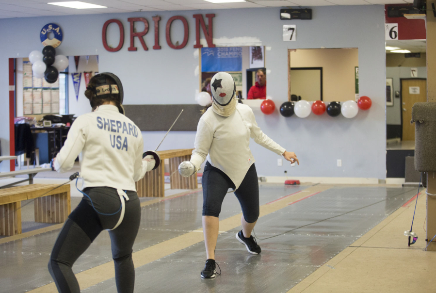 Jazzy Shepard, left, spars with Kaela Meeham at Orion Fencing on Sunday afternoon. Orion Fencing in Orchards held a free open house over the weekend.