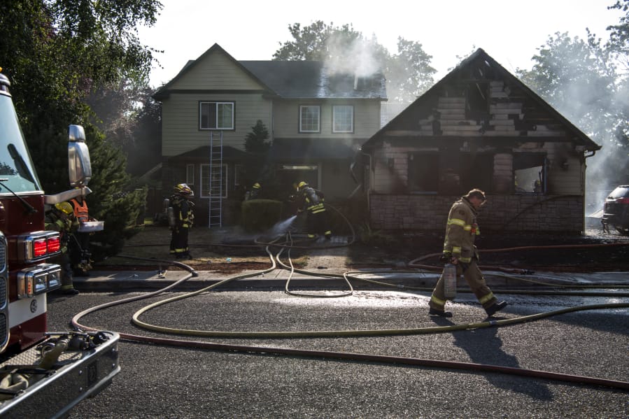 Vancouver Fire Department and Clark County Fire District 6 work a July fire at 11906 N.E. 40th Ave. in Vancouver.
