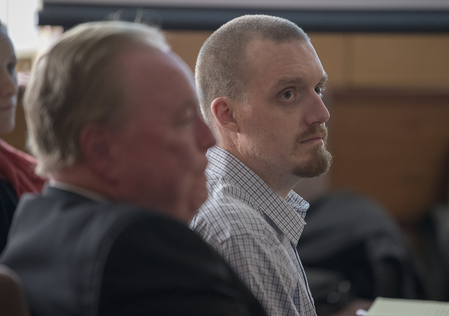 Todd Marjama Jr., right, who is accused of killing his wife, listens to opening statements Nov. 27 in his murder trial in Clark County Superior Court. The case went to the jury Wednesday evening.