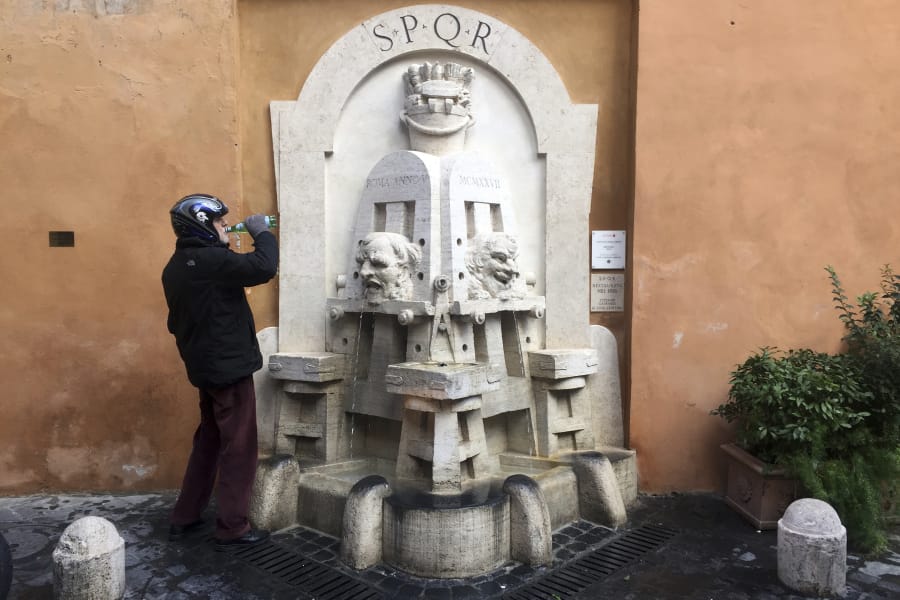A man drinks water he collected from the 1925 Artists fountain last month in Rome’s Via Margutta.