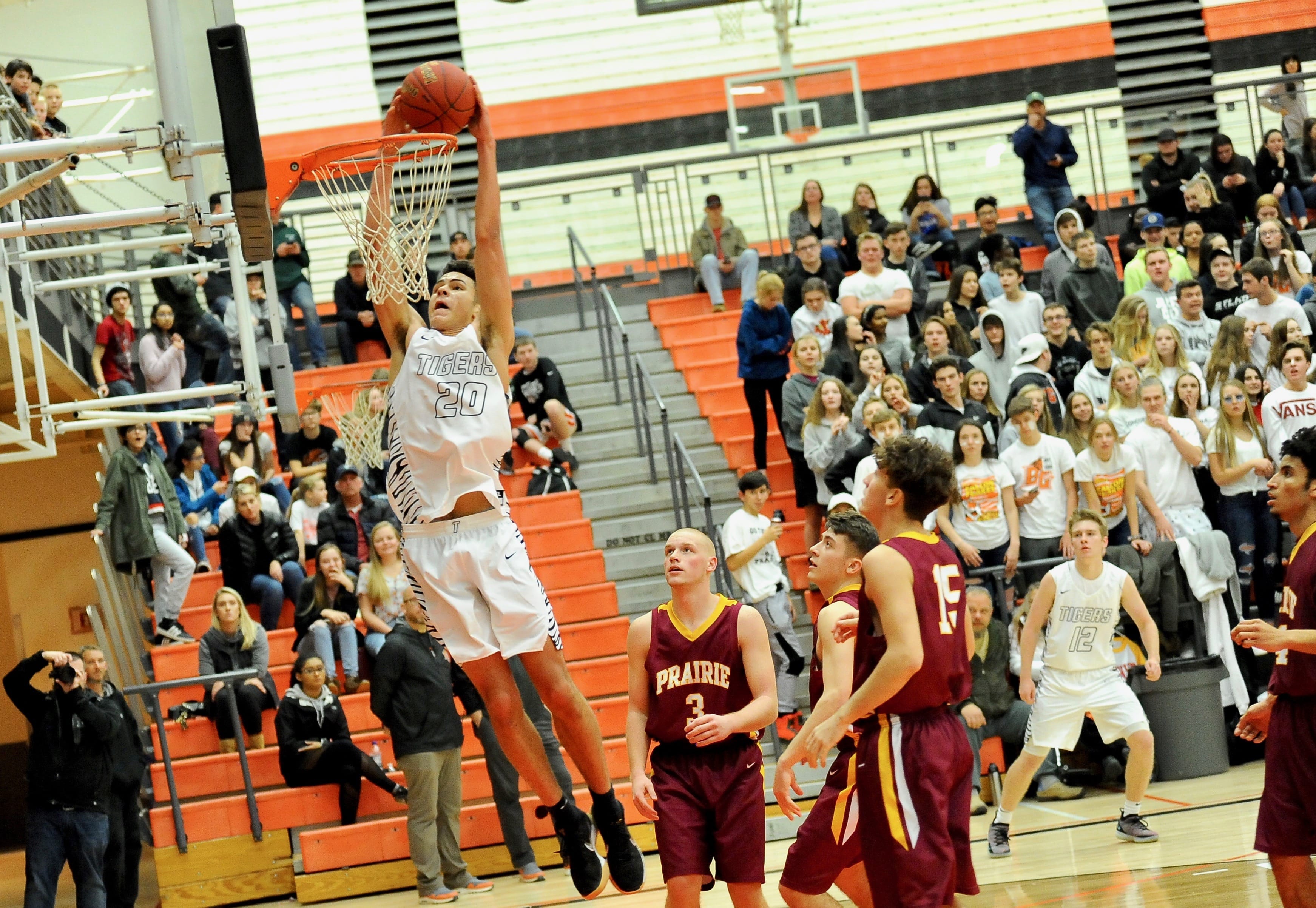 Battle Ground sophomore Kaden Perry finishes a two-handed dunk as Prairie players Kam Osborn, Gabe Lilly and Zeke Dixson look on in the second quarter of a 69-68 overtime win on Tuesday night at Battle Ground High School.