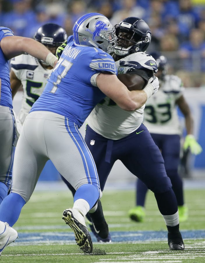 Seattle Seahawks defensive tackle Poona Ford, right, is blocked by Detroit Lions offensive guard Frank Ragnow (77) during the second half of an NFL football game, Sunday, Oct. 28, 2018, in Detroit.