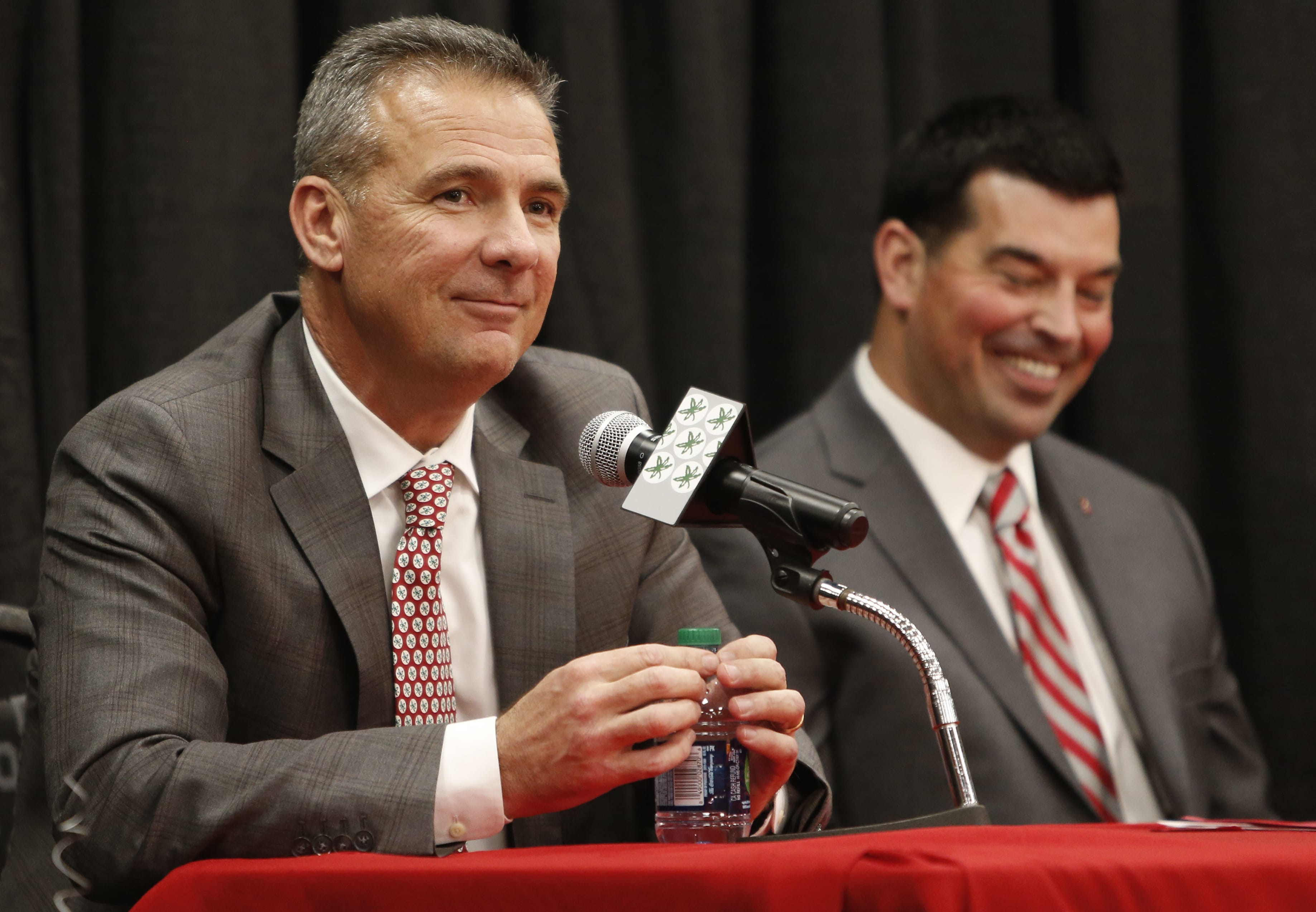 Ohio State NCAA college football head coach Urban Meyer, left, answers questions during a news conference announcing his retirement Tuesday, Dec. 4, 2018, in Columbus, Ohio. At right is assistant coach Ryan Day.