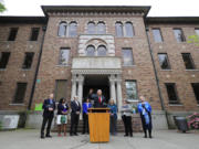 File - In this May 11, 2018 file photo, Washington Gov. Jay Inslee, center, speaks in front of Western State Hospital in Lakewood, Wash. Gov. Inslee unveiled Tuesday, Jan. 11, 2018, his budget and policy plan for fixing the state's struggling mental health system in the coming years. Inslee said he wanted to invest in the troubled Western State Hospital to address safety concerns there, but he didn't mention the rise in assaults at the state's largest psychiatric hospital. (AP Photo/Ted S.
