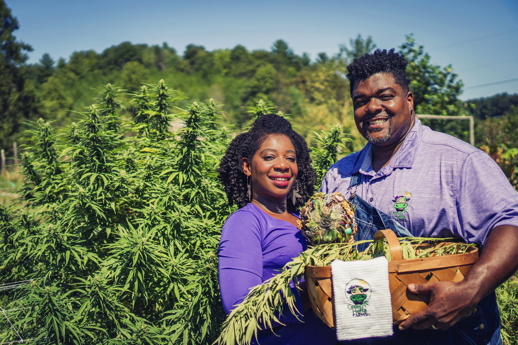 In this September 2018 photo provided by Clarenda "Cee" Stanley-Anderson, Stanley-Anderson and her husband, Malcolm Anderson Sr., pose for pictures of their hemp-farming business, Green Heffa Farms, Inc., in Liberty, N.C. Hemp is about to get the federal legalization that marijuana, its cannabis cousin, craves. That unshackling at the national level sets the stage for greater expansion in an industry seeing explosive growth through demand for CBDs, the non-psychoactive compound in hemp that many see as a way to better health. (Donald Rex Bishop/Green Heffa Farms, Inc.